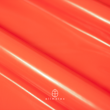 Close-up of tangerine orange glossy latex with Allmotex logo.
