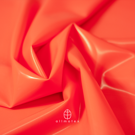 Close-up of tangerine orange glossy latex with Allmotex logo.