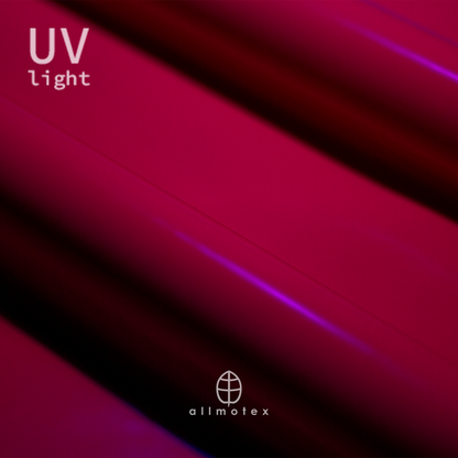 Close-up of fuchsia pink glossy latex reacting to UV light with Allmotex logo.