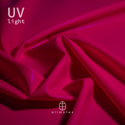 Close-up of fuchsia pink glossy latex reacting to UV light with Allmotex logo.