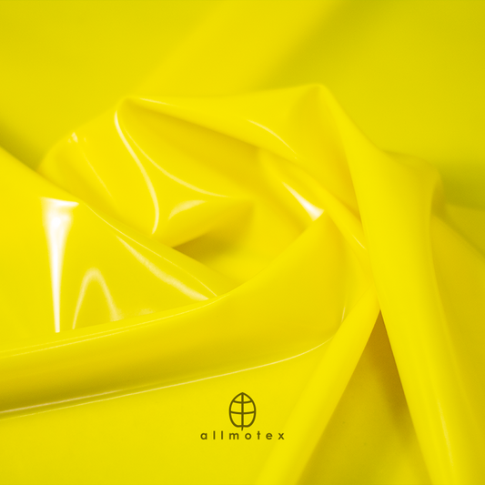Close-up of yellow glossy latex with Allmotex logo.